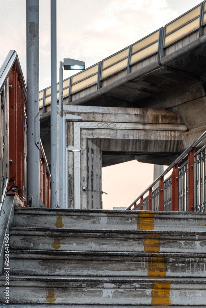 Fototapeta premium Walking overpass with sky train bridge in Bangkok, Thailand.