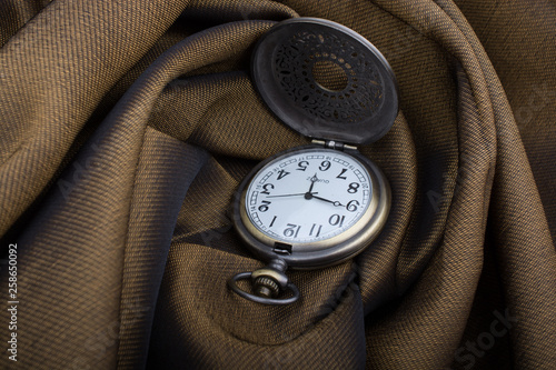 Mechanical pocket watch on afabric photo