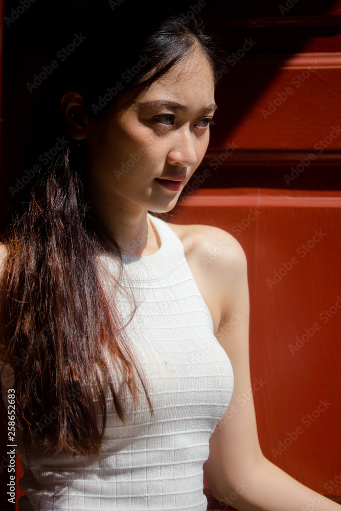 Fototapeta premium Portrait of thai china adult beautiful girl White shirt blue jeans relax and smile