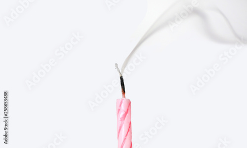 Quadro su tela Candle with smoke blown out on white background.