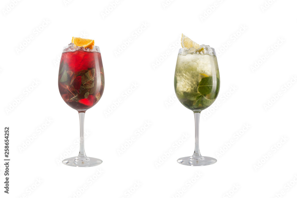 Alcohol cocktail with mint, fruit and berries on a white background. A set of two cocktails in glass goblets on a long leg.