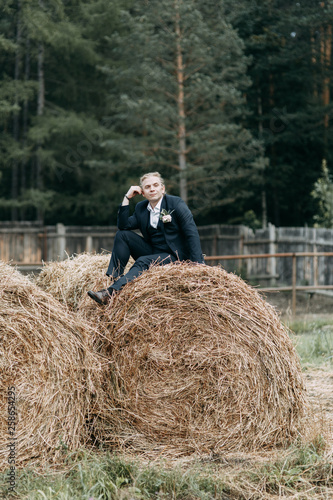 Wedding photo shoot at the stables with hay. Beautiful couple, European wedding.