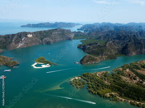 Aerial view of Kilim Geoforest Park. There is sea, river, coastline, mangroves and mountains on the photo. Langkawi, Malaysia.