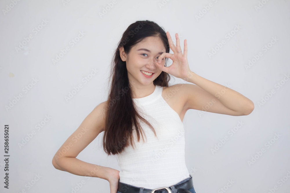 Portrait of thai china adult beautiful girl White shirt blue jeans OK Portrait of thai china adult beautiful girl White shirt blue jeans OK