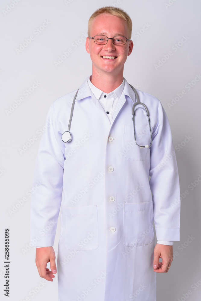 Portrait of happy young blonde man doctor with eyeglasses smiling Portrait of happy young blonde man doctor with eyeglasses smiling
