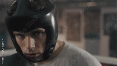 Cinematic shot of the boxer looking into the camera before the fight.