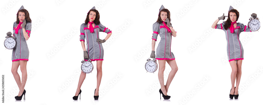 Young stewardess with alarm-clock in time management concept Young stewardess with alarm-clock in time management concept