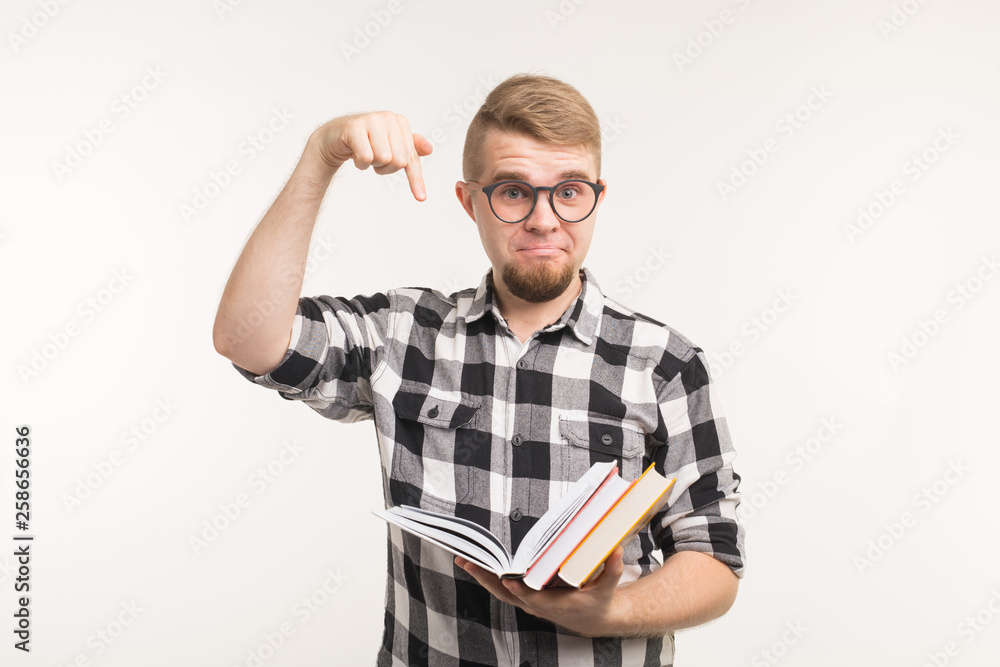 People, knowledge and education concept - Smart man point on books in his hands over white background. People, knowledge and education concept - Smart man point on books in his hands over white background.