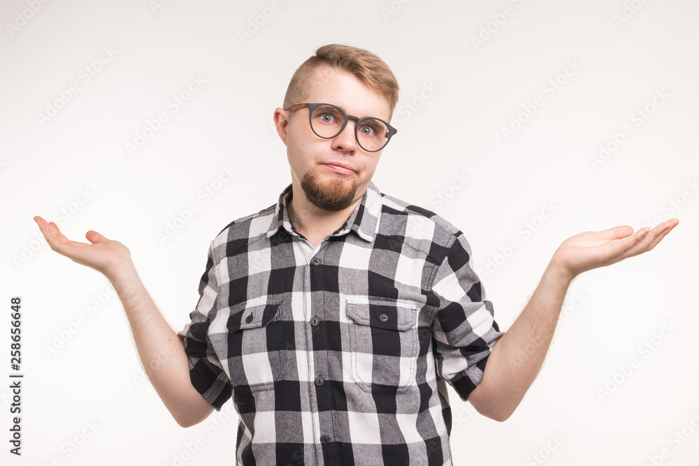 People, emotions and education concept - Student man gesturing shrug shoulders over white background People, emotions and education concept - Student man gesturing shrug shoulders over white background