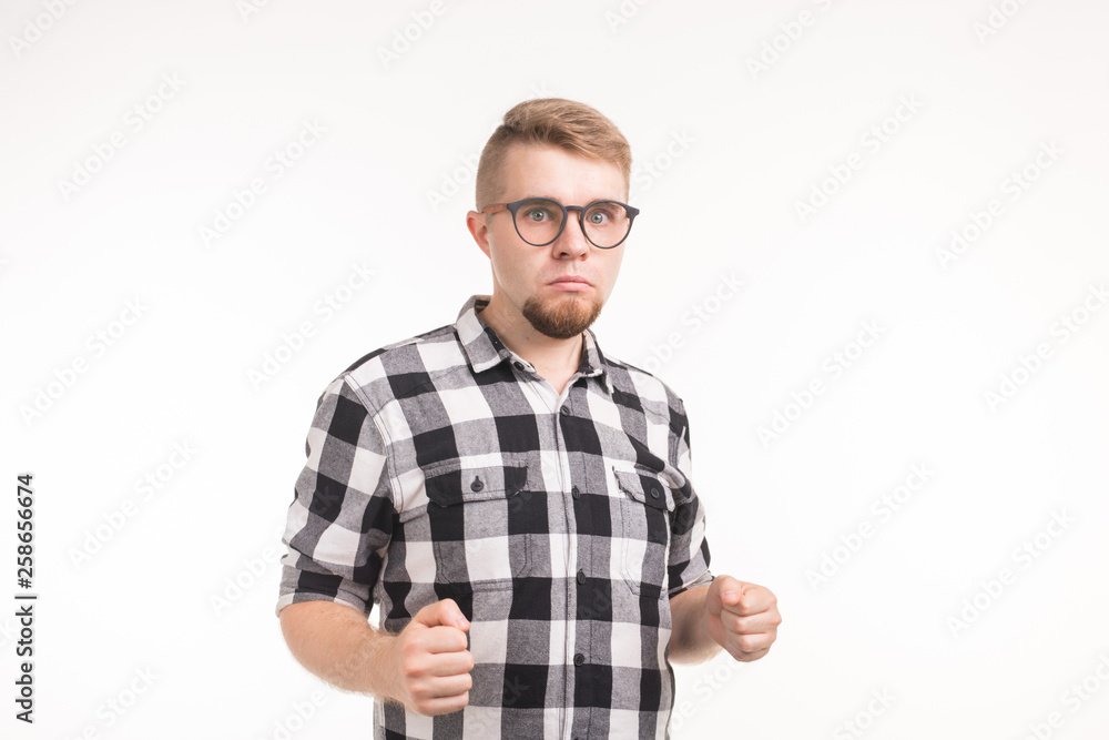 People and emotions concept - Handsome young man in plaid shirt dancing funny over white background People and emotions concept - Handsome young man in plaid shirt dancing funny over white background
