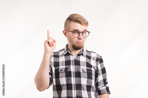 Geek, nerd and education concept - Handsome man in plaid shirt finger gesture up over white background