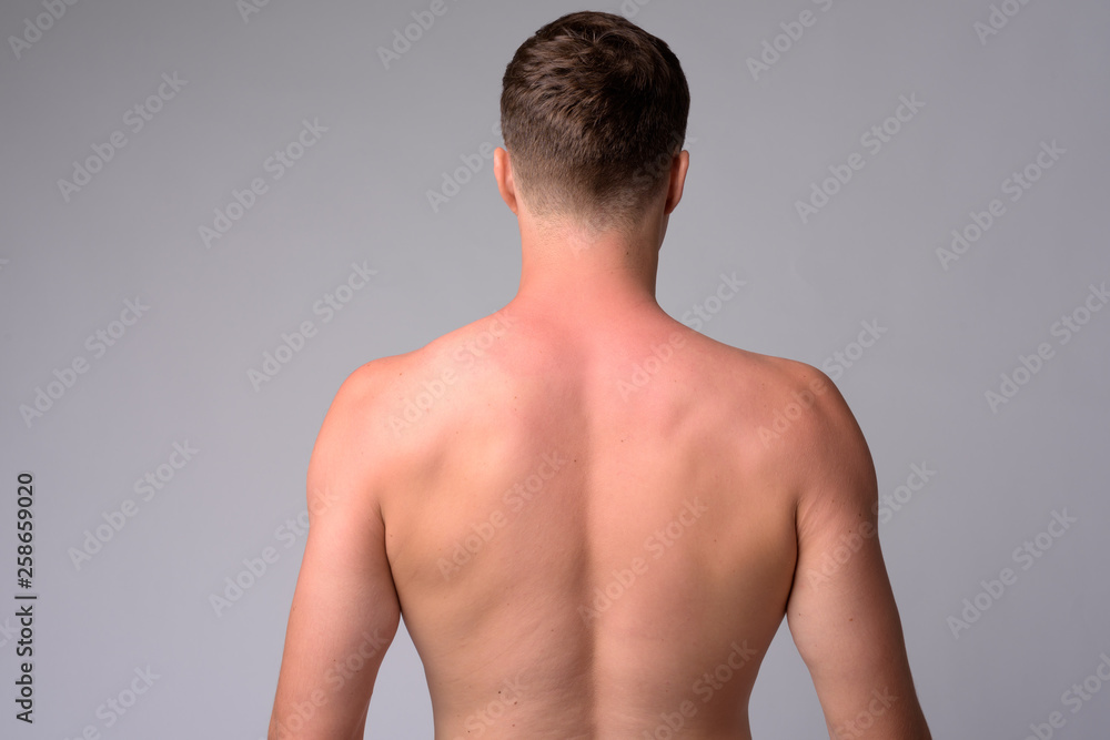 Fototapeta premium Rear view of young muscular man shirtless