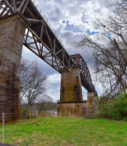 Train track railway bridge views along the Shelby Bottoms Greenway and Natural Area over Cumberland River frontage trails, Music City Nashville, Tennessee. United States.