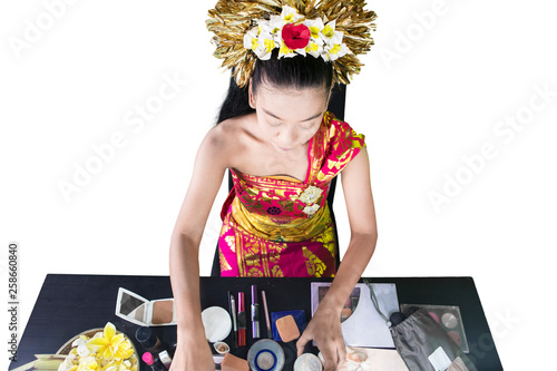 Traditional dancer doing makeup on studio photo