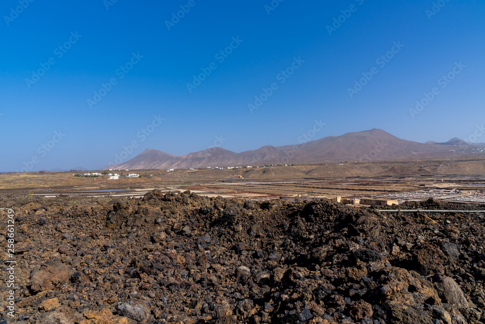 Spain, Lanzarote, Natural salt flats salinas de janubio between black lava and red mountains
