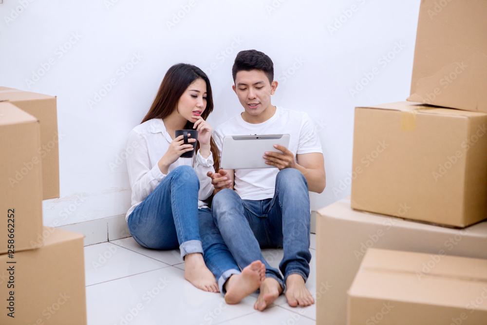 Young man resting with his wife in a new house Young man resting with his wife in a new house