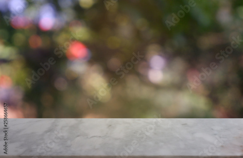 Empty white table in front of abstract blurred green of garden and nature light background. For montage product display or design key visual layout - Image