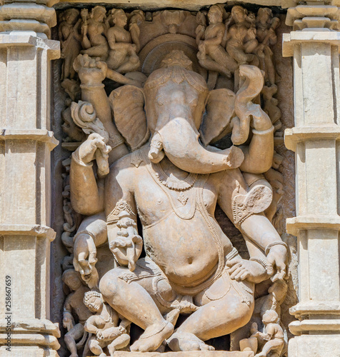 ancient stone sculptures carved into the wall of the temple Ganesa photo