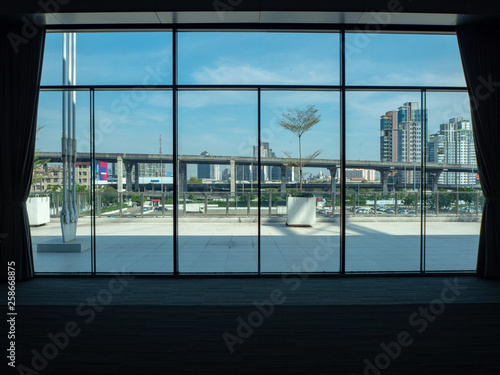City view with cloudy blue sky from large window in convention building