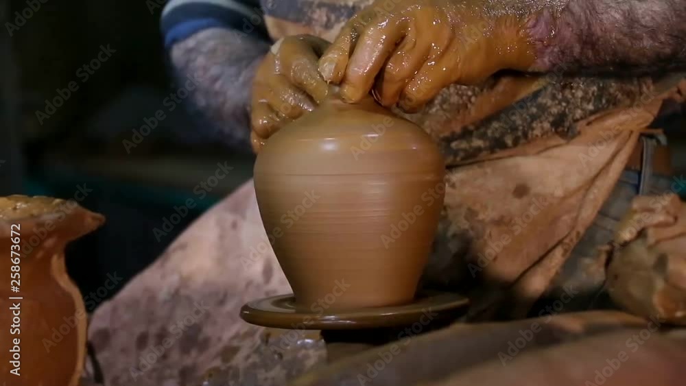 Senior Potter making clay pottery Senior Potter making clay pottery