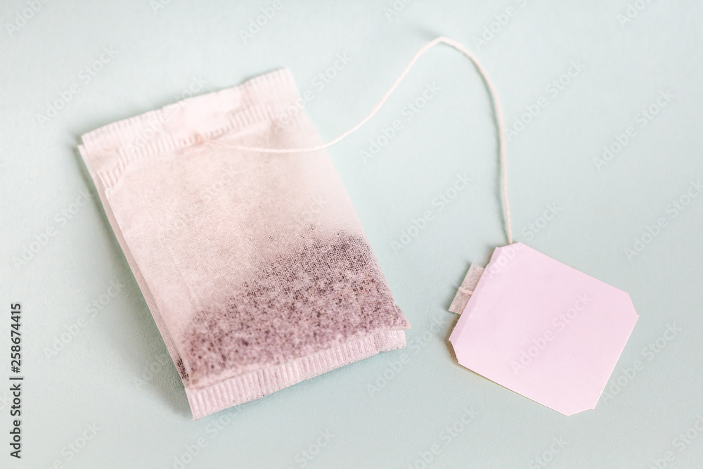 tea bags with white label isolated on light background tea bags with white label isolated on light background
