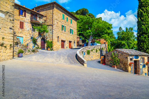Fototapeta Naklejka Na Ścianę i Meble -  Tuscany street and rustic stone houses decorated with flowers, Monticchiello