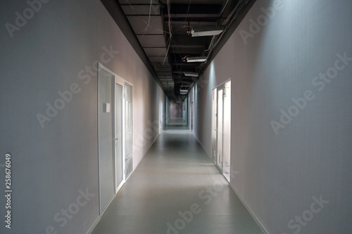 Long narrow corridor with doors in the office or workplace