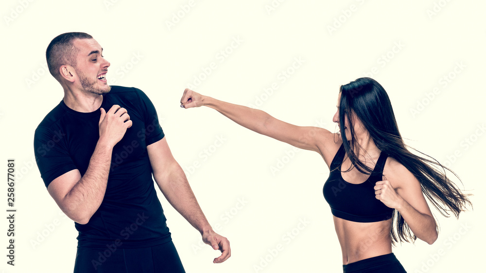 Fit athletic girl having kickboxing training with personal instructor, image with warm vintage toning Fit athletic girl having kickboxing training with personal instructor, image with warm vintage toning