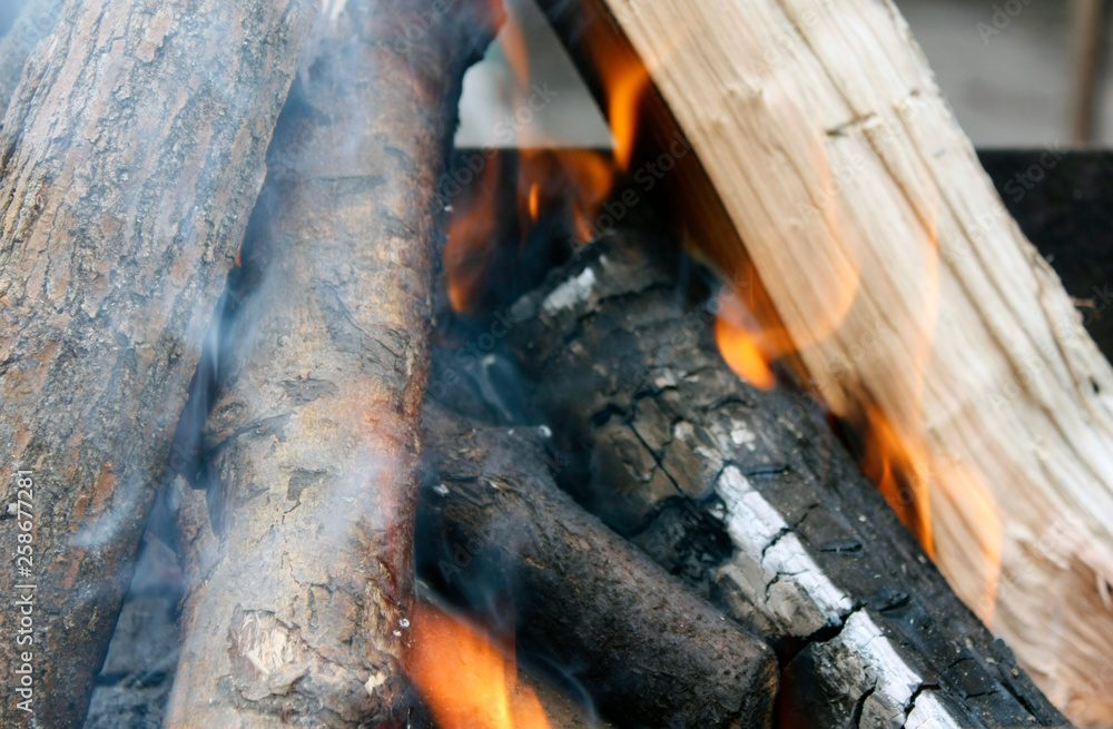 Fire. Closeup of pile of wood burning with flames in the fireplace. Fire. Closeup of pile of wood burning with flames in the fireplace.
