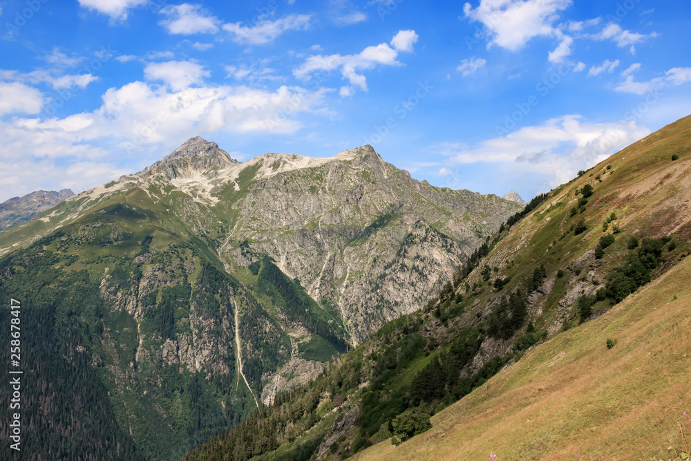 Panorama of mountains scene with dramatic blue sky in national park of Dombay