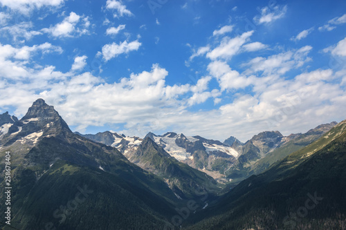 Panorama of mountains scene with dramatic blue sky in national park of Dombay © TravelFlow