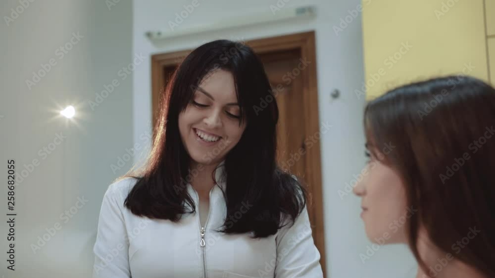Dentist praparing for treatment place and smiles to girl 4K Dentist praparing for treatment place and smiles to girl 4K