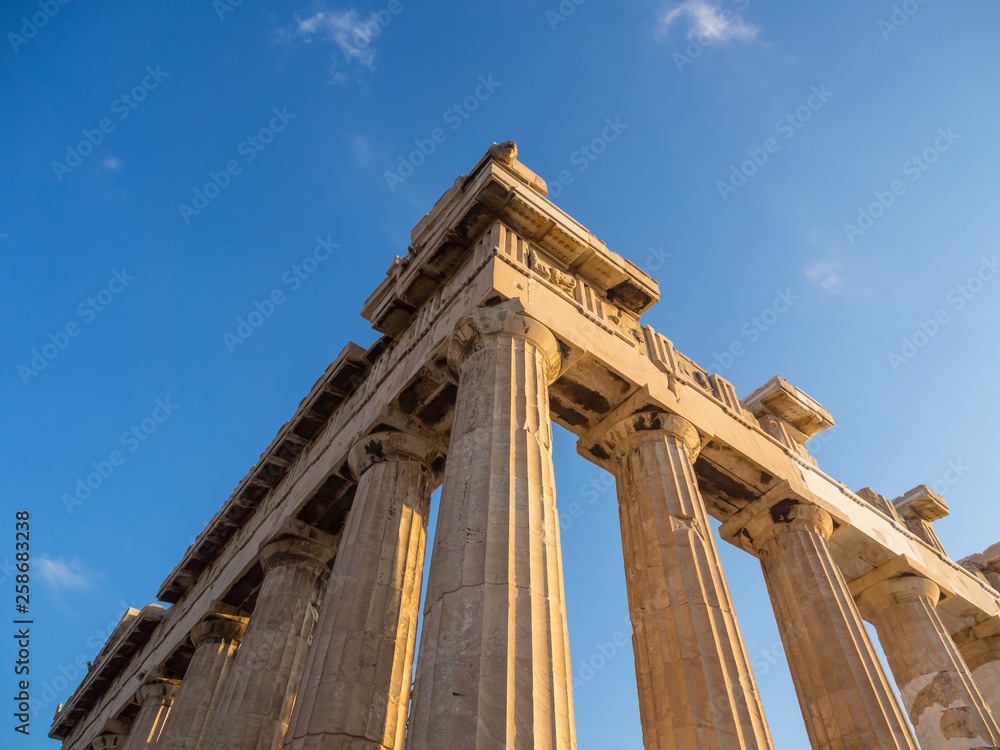 View of corner of Parthenon and its columns on Acropolis, Athens, Greece against blue sky
