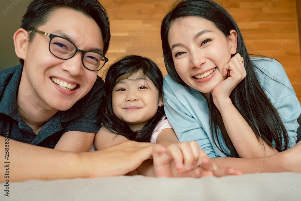 happiness joyful asian family mom dad daughter laydown together with fun play kiss on bed portrait of asian family people home background happiness joyful asian family mom dad daughter laydown together with fun play kiss on bed portrait of asian family people home background