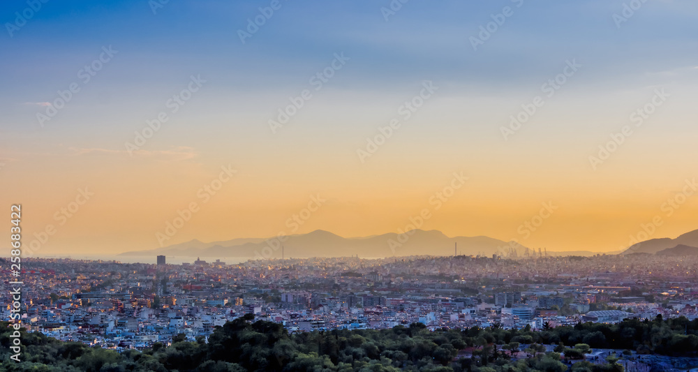 View of Athens and Pireus port from Acropolis hill against sunset, Greece