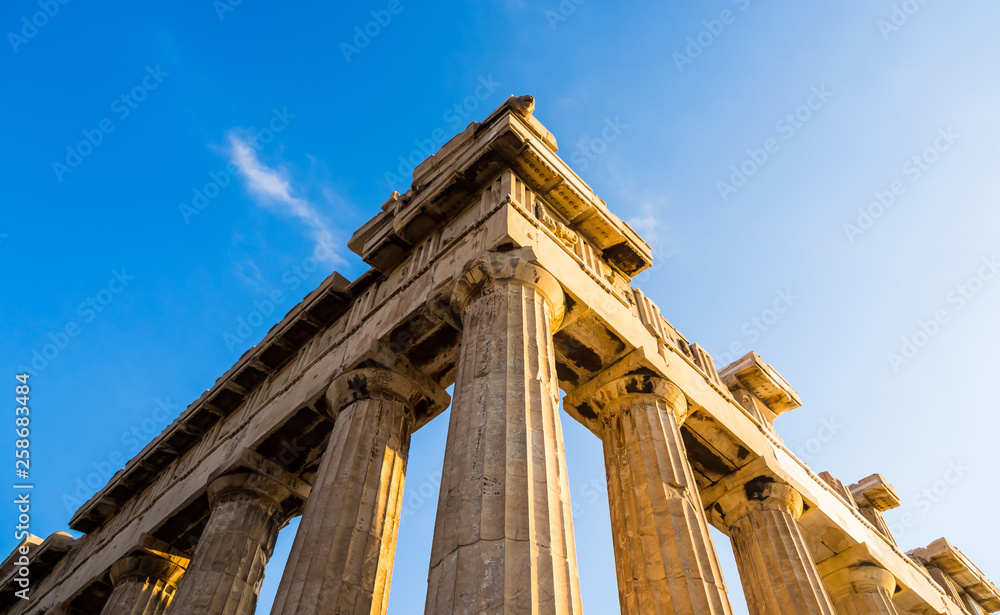 View of corner of Parthenon and its columns on Acropolis, Athens, Greece against blue sky