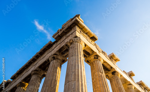 View of corner of Parthenon and its columns on Acropolis, Athens, Greece against blue sky