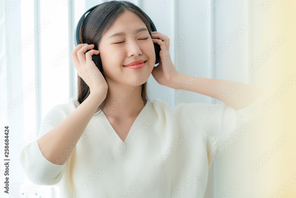 attractive asian beautiful woman enjoy music from headphone with happiness and joyful,portrait of asian white dress woman attractive asian beautiful woman enjoy music from headphone with happiness and joyful,portrait of asian white dress woman