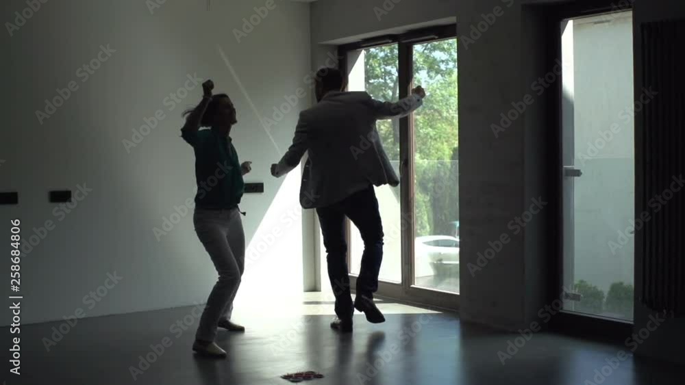 Happy couple dancing at their new home Happy couple dancing at their new home