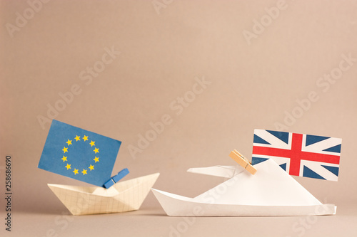 paper ship with Flags of European Union and United Kingdom, Brexit UK EU concept shipment or free trade agreement and membership 