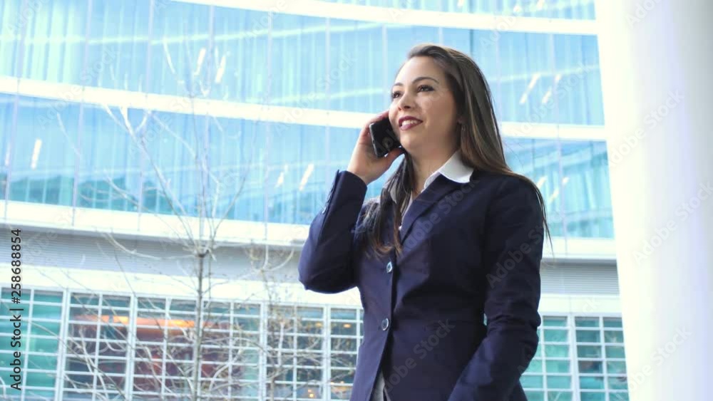 Female manager on the phone outdoor in a modern city setting Female manager on the phone outdoor in a modern city setting