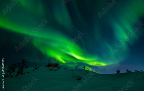 Aurora Borealis over Volosnaya Mountain in Kandalaksha in winter, Russia, Murmansk region photo