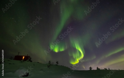 Aurora Borealis over Volosnaya Mountain in Kandalaksha in winter, Russia, Murmansk region