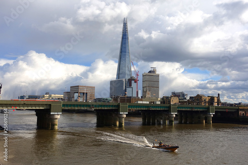 Photo from iconic skyscraper "the Shard" tallest building in Europe as seen in City of London with beautiful clouds and blue sky, London, United Kingdom