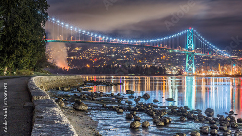 Vancouver, British Columbia. Canada Long exposure from below of the Lions Gate Bridge with lights trail, glitters and clouds. photo