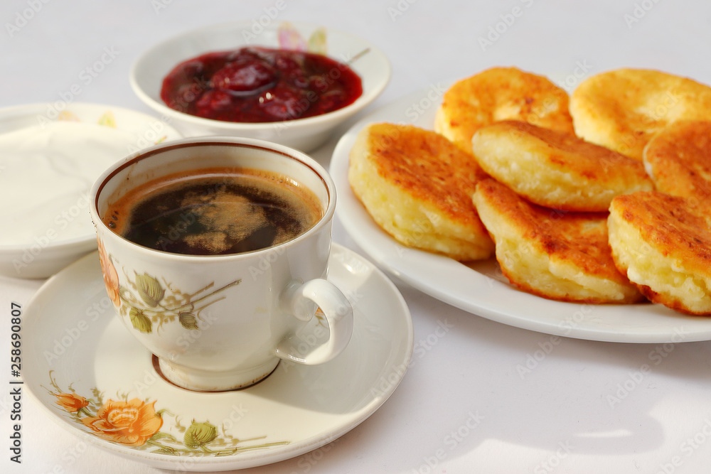 Fragrant ruddy golden with a brown crust freshly cooked syrup curds(cheesecake) with strawberry jam and sour cream piping hot. Fragrant ruddy golden with a brown crust freshly cooked syrup curds(cheesecake) with strawberry jam and sour cream piping hot.