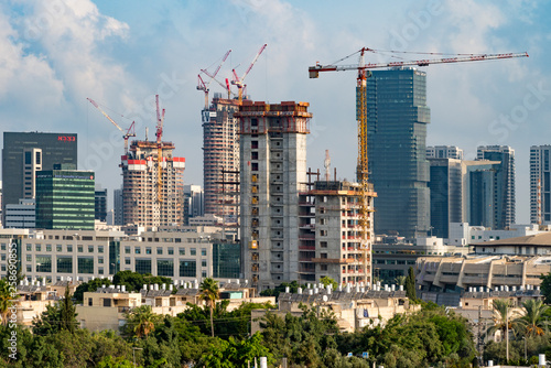 Tel Aviv's skyline high rise construction with cranes and water heaters, Israel	