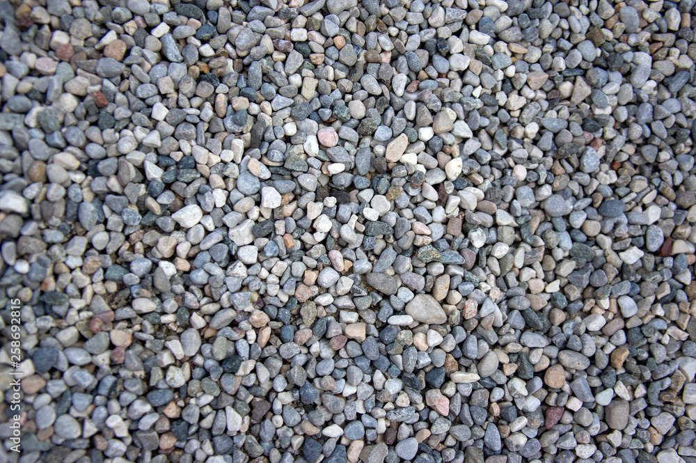 Small gray river stones background, simplicity texture in daylight, group of color stones Small gray river stones background, simplicity texture in daylight, group of color stones