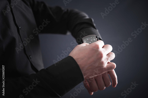 Man adjusting his wristwatch.