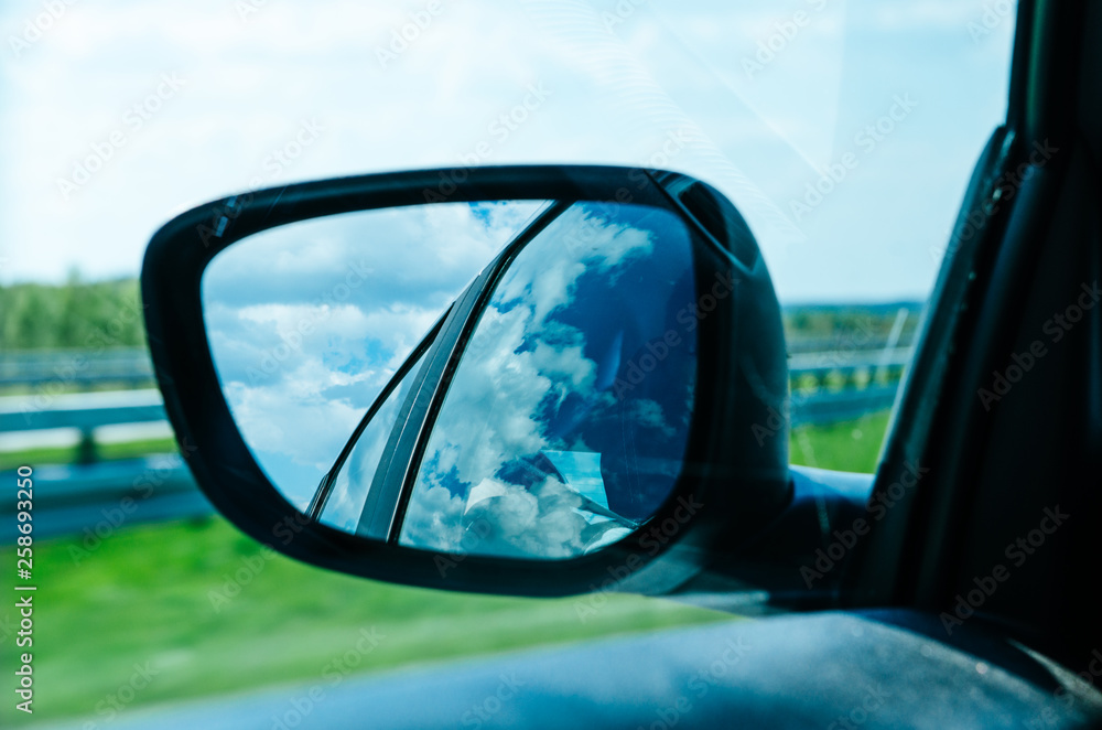 Landscape in the sideview mirror of a car